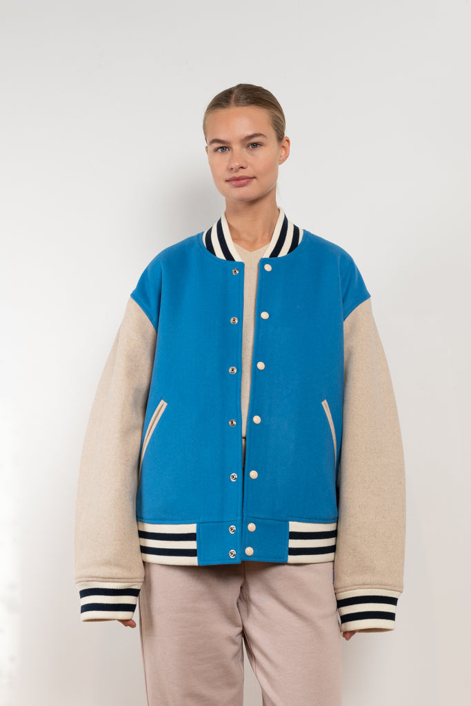 The Wool Bomber 104 by Acne Studios has contrast-coloured sleeves and is detailed with a ribbed neckline, cuffs and hem and adorned with a face logo patch