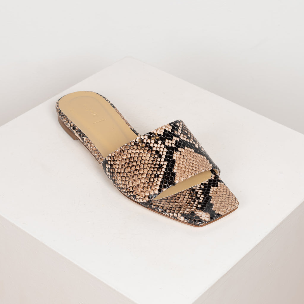 The Anna Slides by Aeyde are iconic lightweight flat slip on sandals with a squared toe, minimal heel in a snake print leatherThe Anna Slides by Aeyde are iconic lightweight flat slip on sandals with a squared toe, minimal heel in a snake print leather