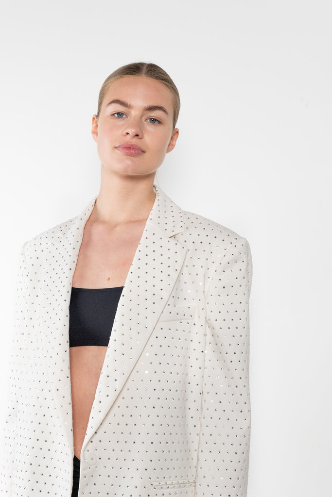 The Guia Blazer by The Andamane is a relaxed oversized blazer with all-over crystals in a bright white