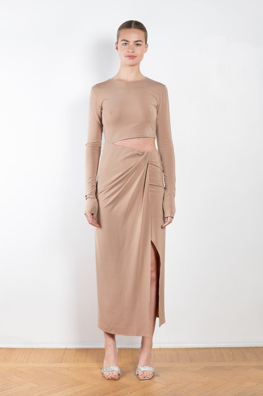 The Gia Dress by The Andamane is a midi dress with a cut-out detail and side slit