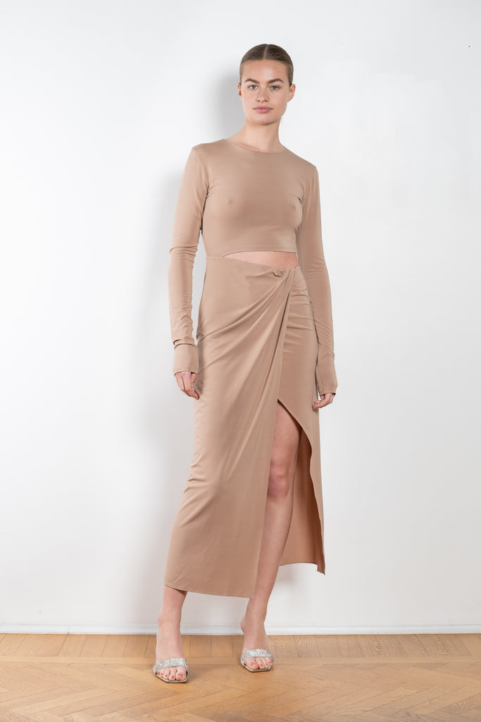 The Gia Dress by The Andamane is a midi dress with a cut-out detail and side slit