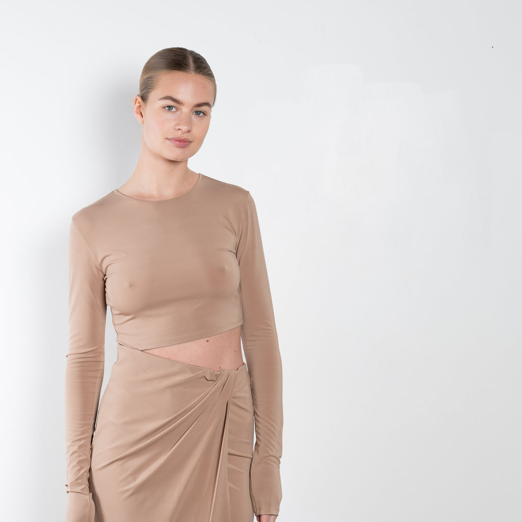 The Gia Dress by The Andamane is a midi dress with a cut-out detail and side slit