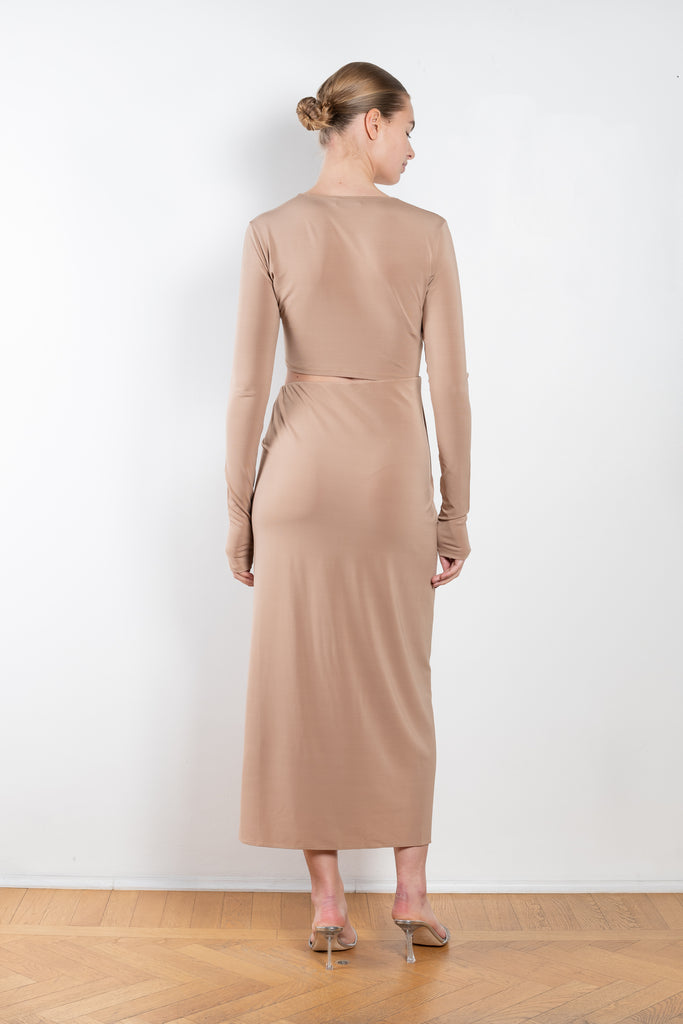 The Gia Dress by The Andamane is a midi dress with a cut-out detail and side slit