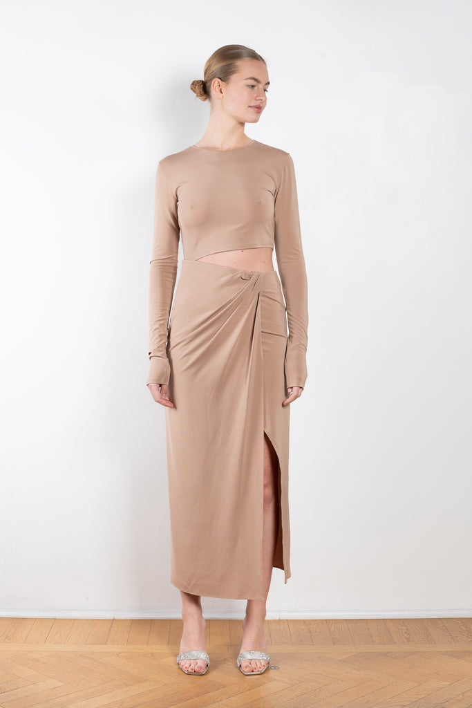 The Gia Dress by The Andamane is a midi dress with a cut-out detail and side slit