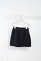 The Gioia Skirt by The Andamane is a black high waisted split mini skirt