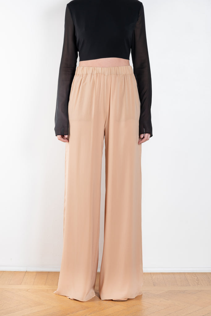 The Lena Pants by The Andamane are high waist silk trousers with a flattering wide leg in a silk chiffon summer blush