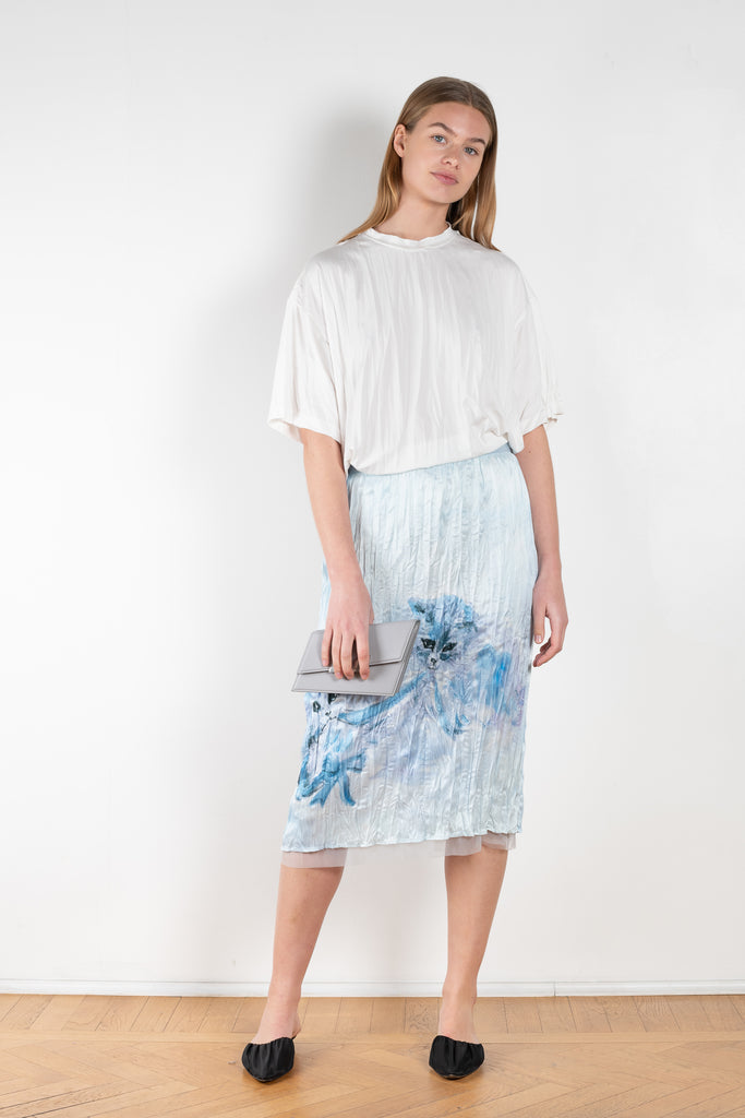 The Print Cat Skirt 502 is a high waisted midi skirt made from a satin fabric with a crinkled luminous and fluid appearance and a seasonal print by artist Karen Kilimnik
