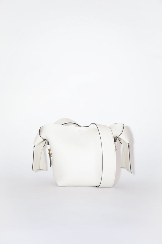 The Musubi Mini Bag by Acne Studios is a signature bag with twisted knots in a luxurious matte grain leather
