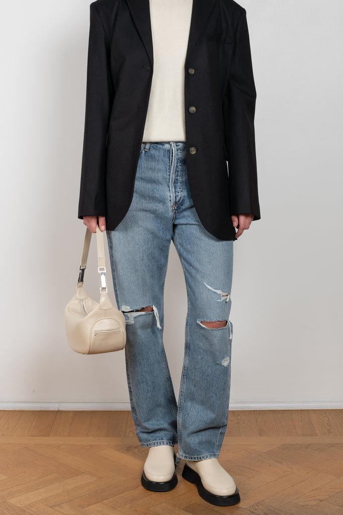 The 90'S Jeans by Agolde in color streamline is a relaxed mid rise straight leg jeans in a distressed mid blue wash