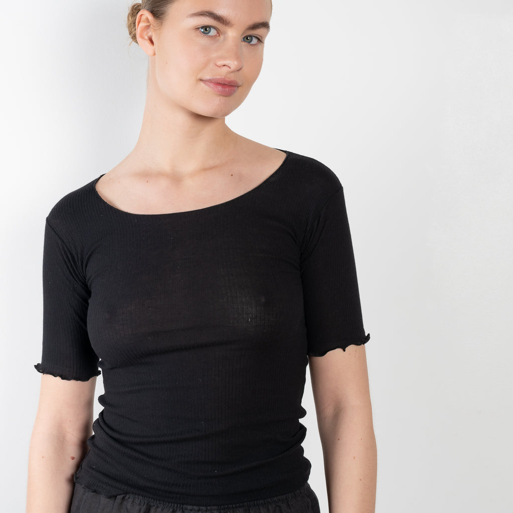 The Pama 3/4 Sleeve Tee by Baserange is a fitted cotton ribbed tee with exposed seams and lettuce edge details at hem and cuffs