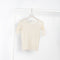 The Pama 3/4 Sleeve Tee by Baserange is a fitted cotton ribbed tee with exposed seams and lettuce edge details at hem and cuffs