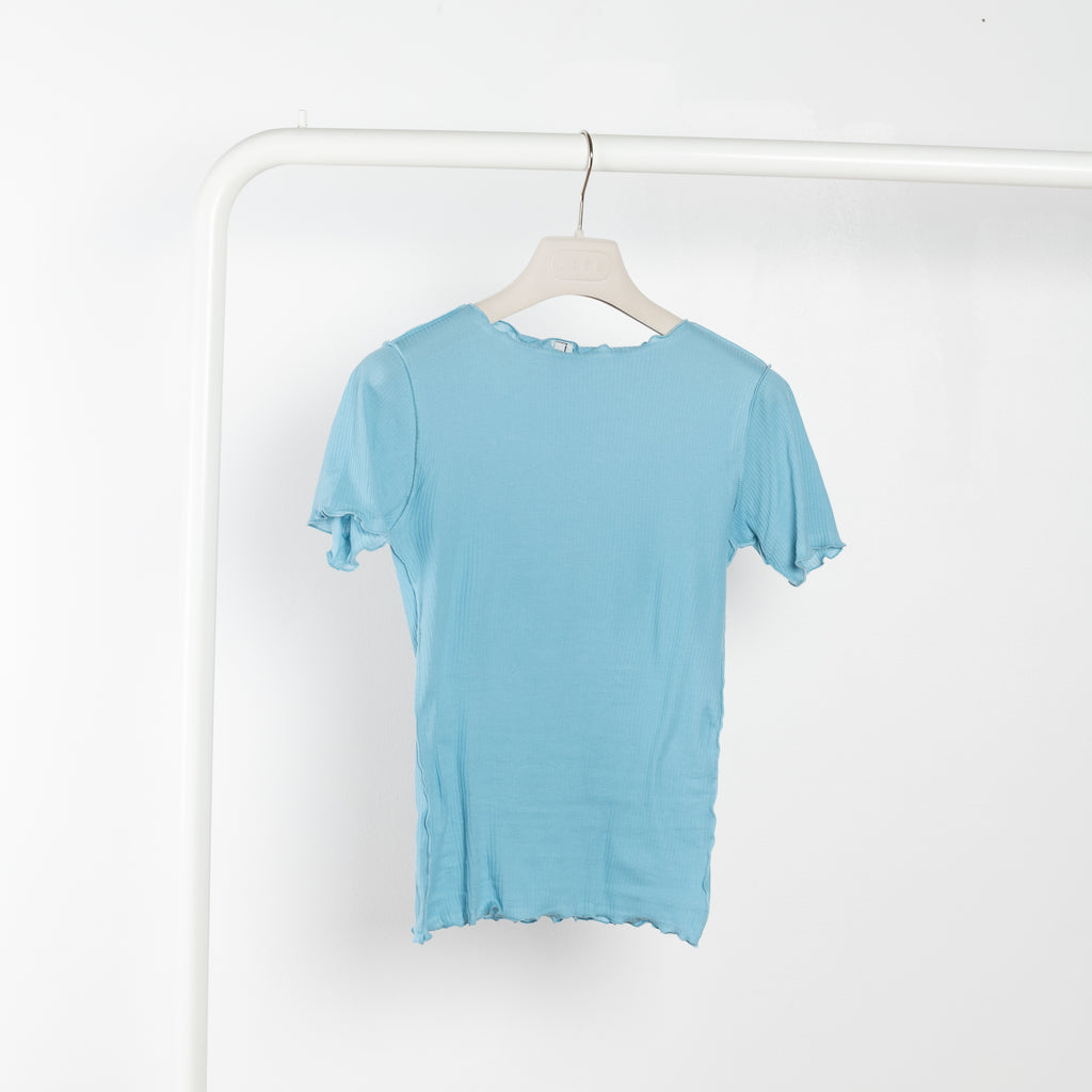 The Vein Tee by Baserange is a fitted cotton ribbed tee with exposed seams and lettuce edge details at hem and cuffs