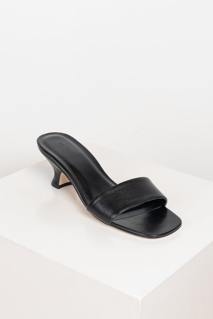 The Freddy Mules by By Far are squared toe mules in a soft and supple leather with a 5 cm curved heel