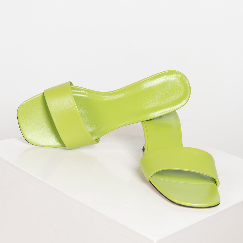 The Freddy Mules by By Far are squared toe mules in a soft and supple leather with a 5 cm curved heel