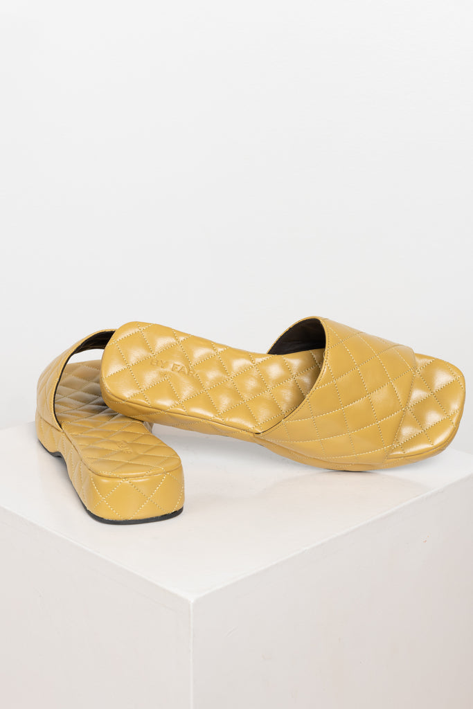 The Lilo Slides by By Far are chunky quilted leather slides with an extra padded footbed