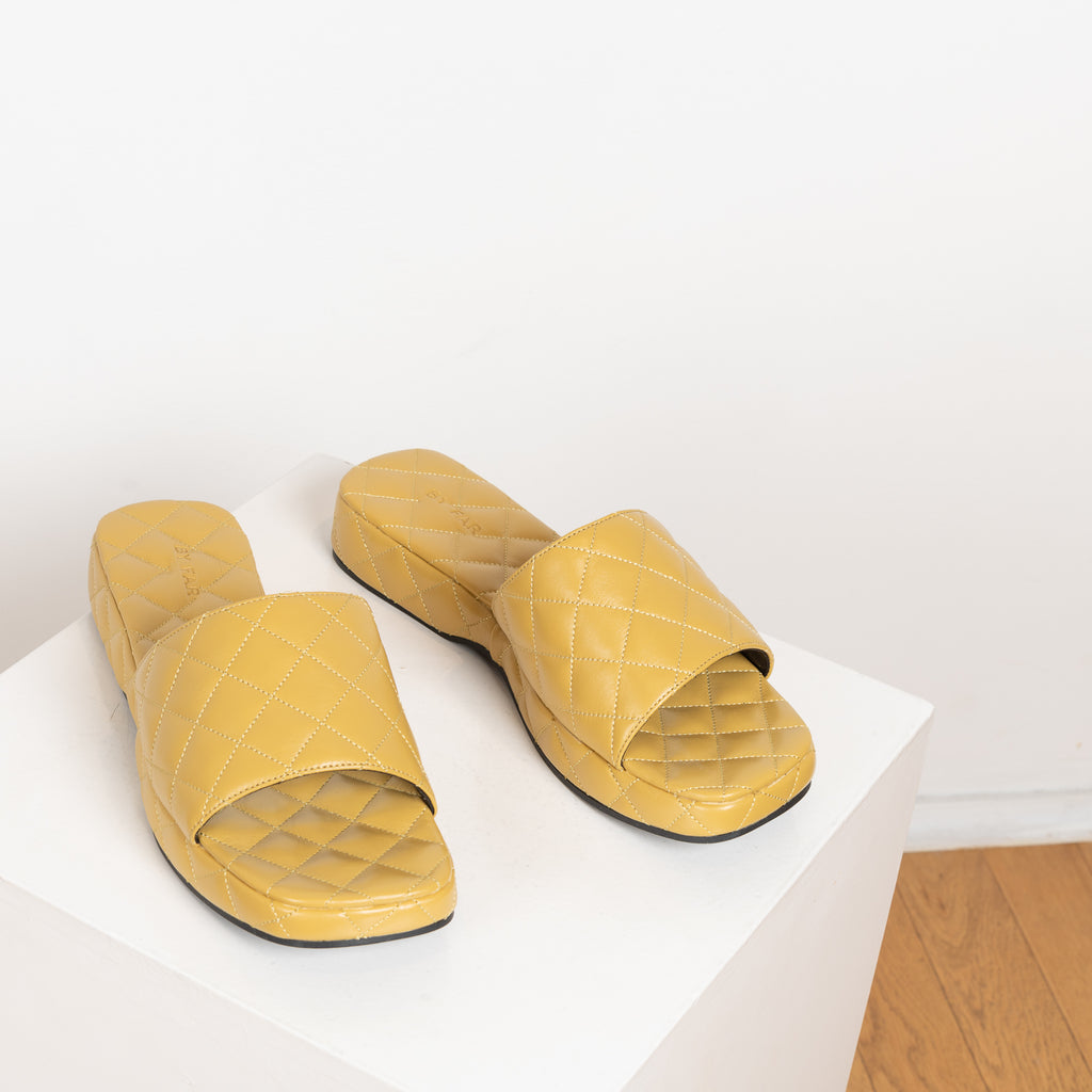 The Lilo Slides by By Far are chunky quilted leather slides with an extra padded footbed
