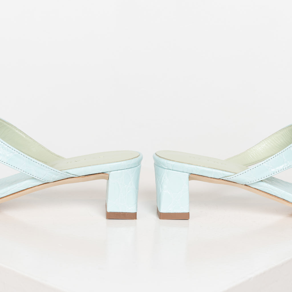 The Shawn Mules by By Far are squared toe flip-flop mules with a sturdy 4 cm block heel