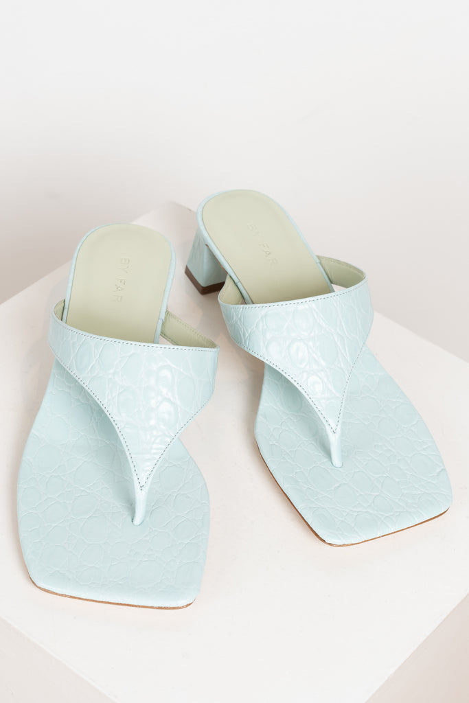 The Shawn Mules by By Far are squared toe flip-flop mules with a sturdy 4 cm block heel