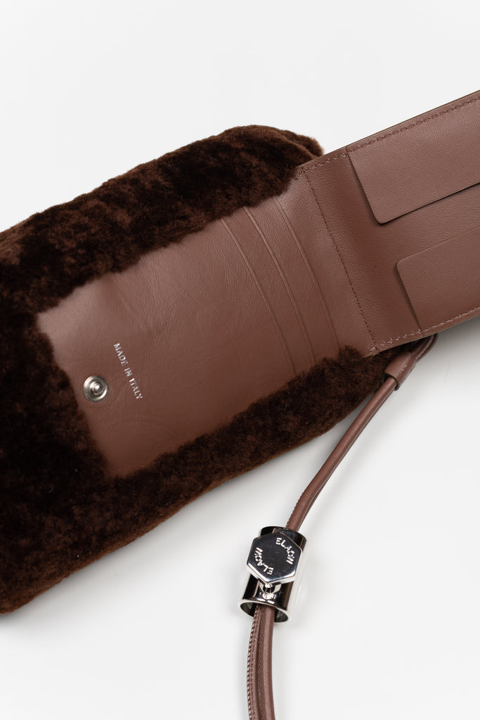 The PXL1JW Shearling Bag by ELAOW is a micro shearling bag to contain your phone, headphones, coins and cards in soft nappa leather with a  jewel strap 