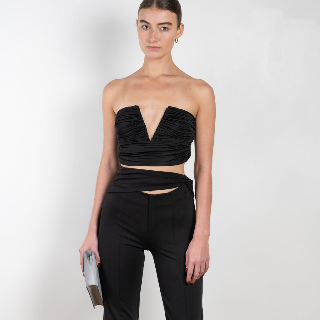 The Afega Pants by GAUGE81 are high waisted spandex trousers with a wrap accent that accentuates the waist and elevates any look