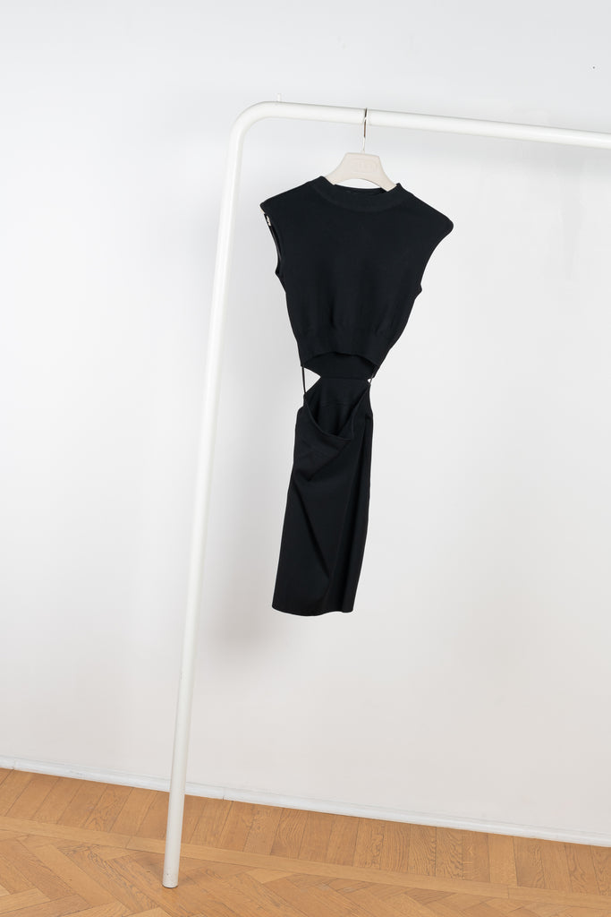The Mao Dress by GAUGE81 is a sleeveless bodycon dress with a mock neck and waist slit detail at the front creating the illusion of two separate pieces