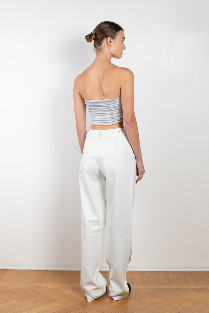 The Sesis Top by GAUGE81 is a minimal bustier top with ruching creating waves and a bold V neck
