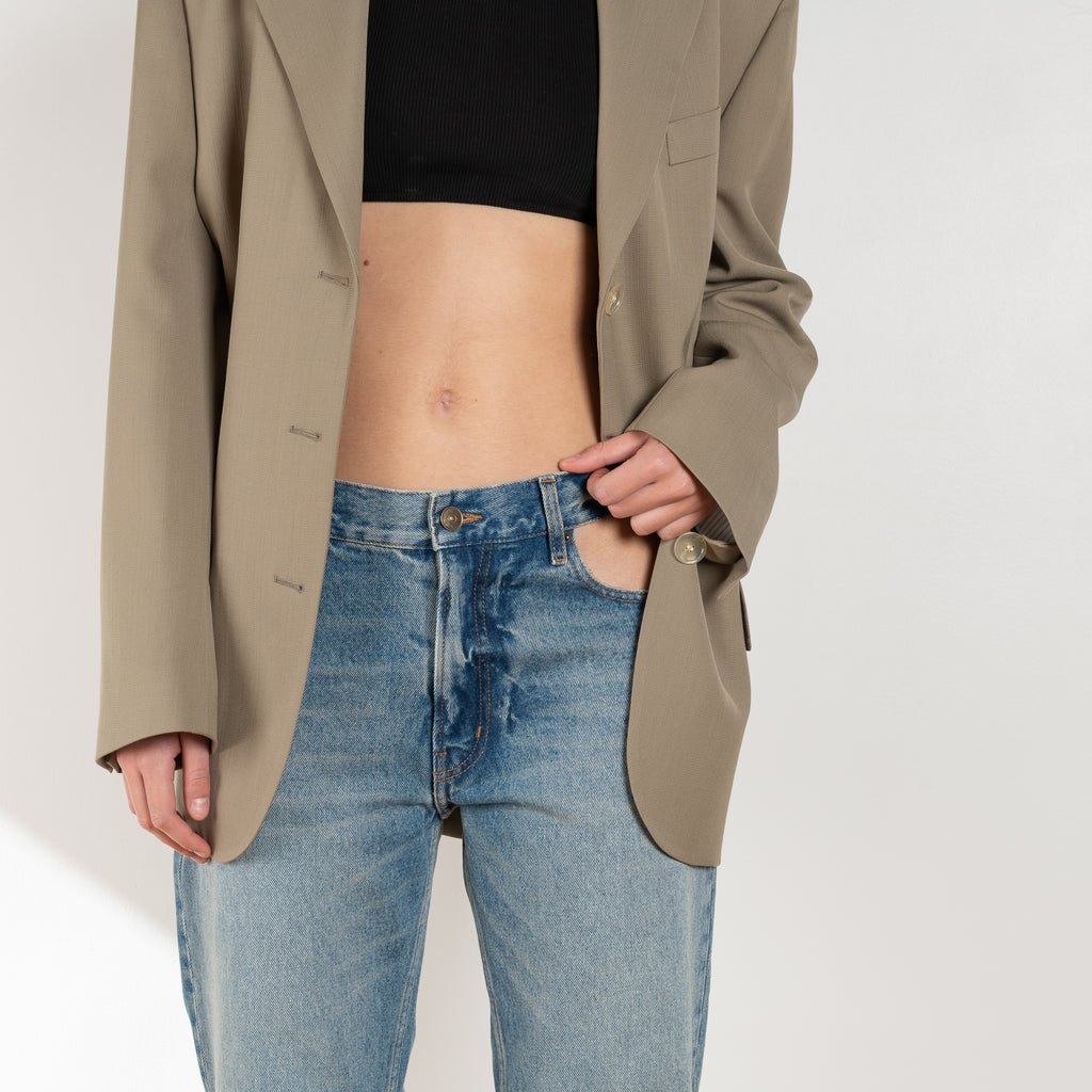 The Cut-out Jeans by Gauchere is a signature denim with a relaxed fit and a cut-out detail at the hips