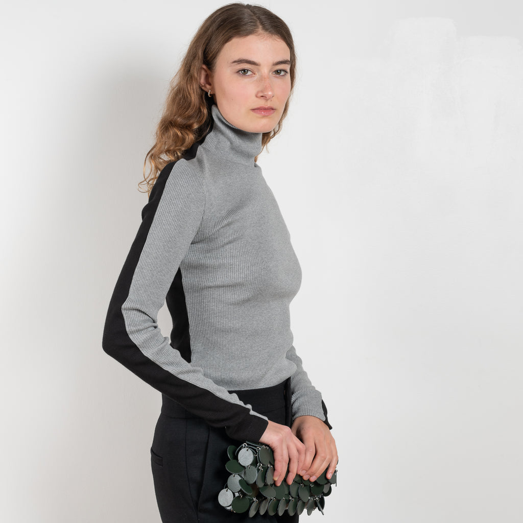The Two Tone Top by Gauchere is a turtleneck top with a long slim fit in ribbed two tone cotton