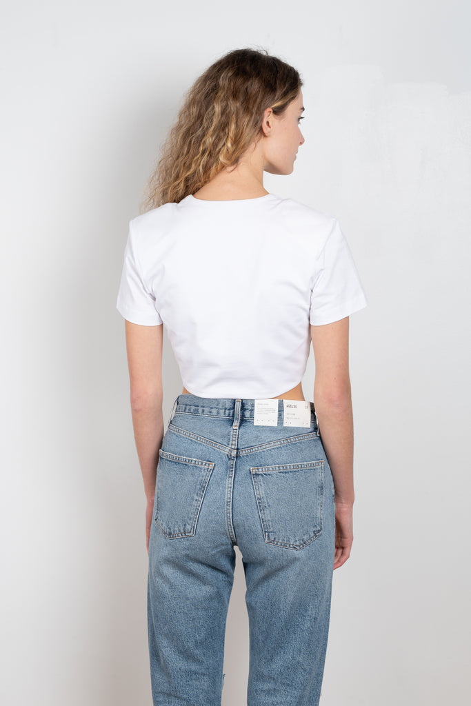 The Keila Top by Gauge81 is a crop top with twist detail and shoulder pads made out of soft organic cotton