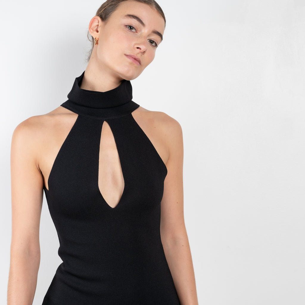 The Maioris Dress by GAUGE81 is a knitted slim cut mini dress with a halter/turtle neck and a bold front cut out