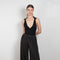 The Mezi Bodysuit by Gauge81 is a black bodysuit with a tan-colored mesh upper part