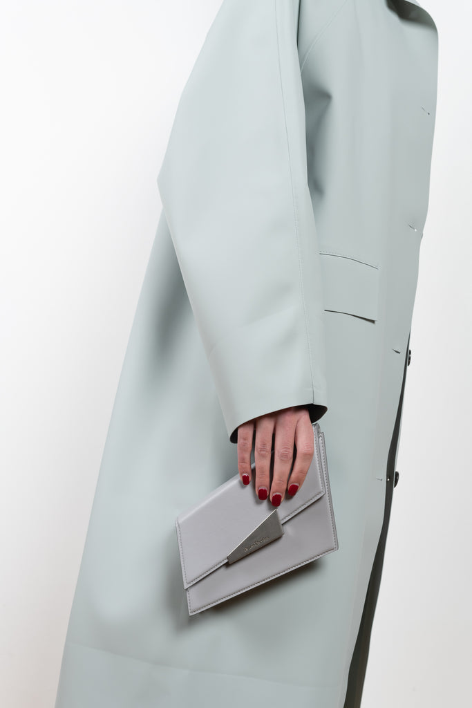 The Rubber Coat by Kassl Editions is a below the knee length rain coat in a soft and fluid rubber fabric