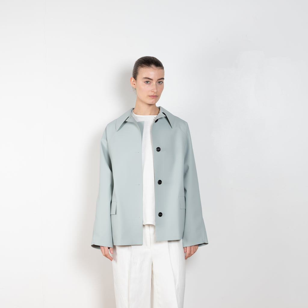 The Rubber Coat by Kassl Editions is a on-the-hip length rain coat in a soft and fluid rubber fabric