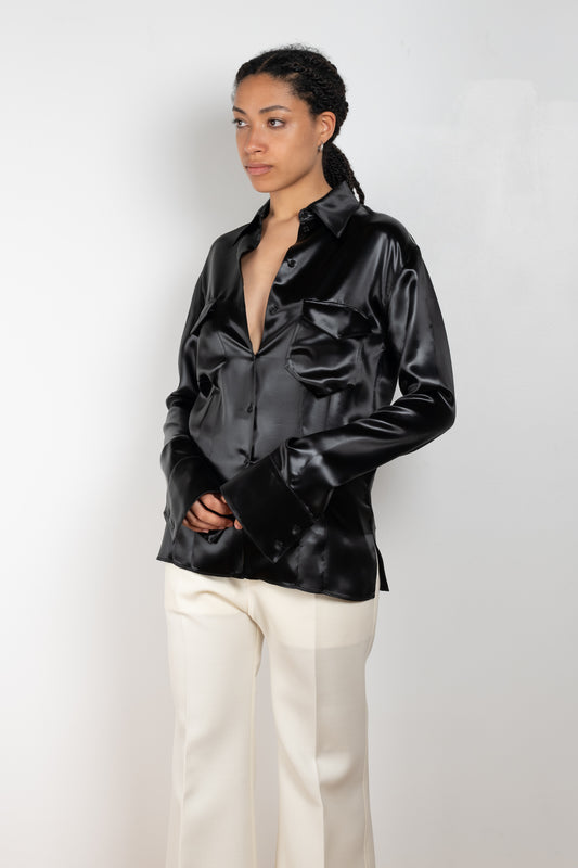 The Satin Shirt by Kwaidan Editions is a fitted buttoned shirt with extra long sleeves in a black satin