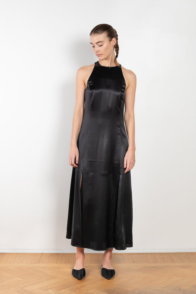 The Mina Dress by Loulou Studio is a long sleeveless silk dress with feminine side slits and a high neck