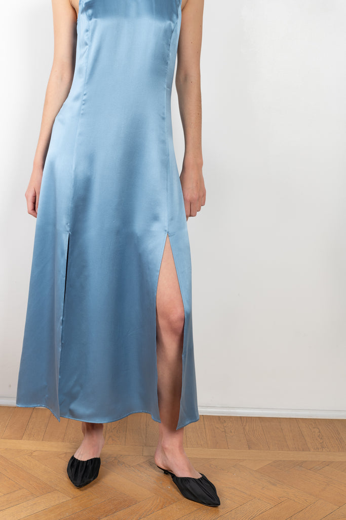 The Mina Dress by Loulou Studio is a long sleeveless silk dress with feminine side slits and a high neck