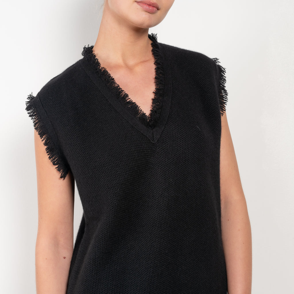 The Lola Dress is by Lisa Yang is a mini dress in a structured knitted pattern cashmere with fringed details