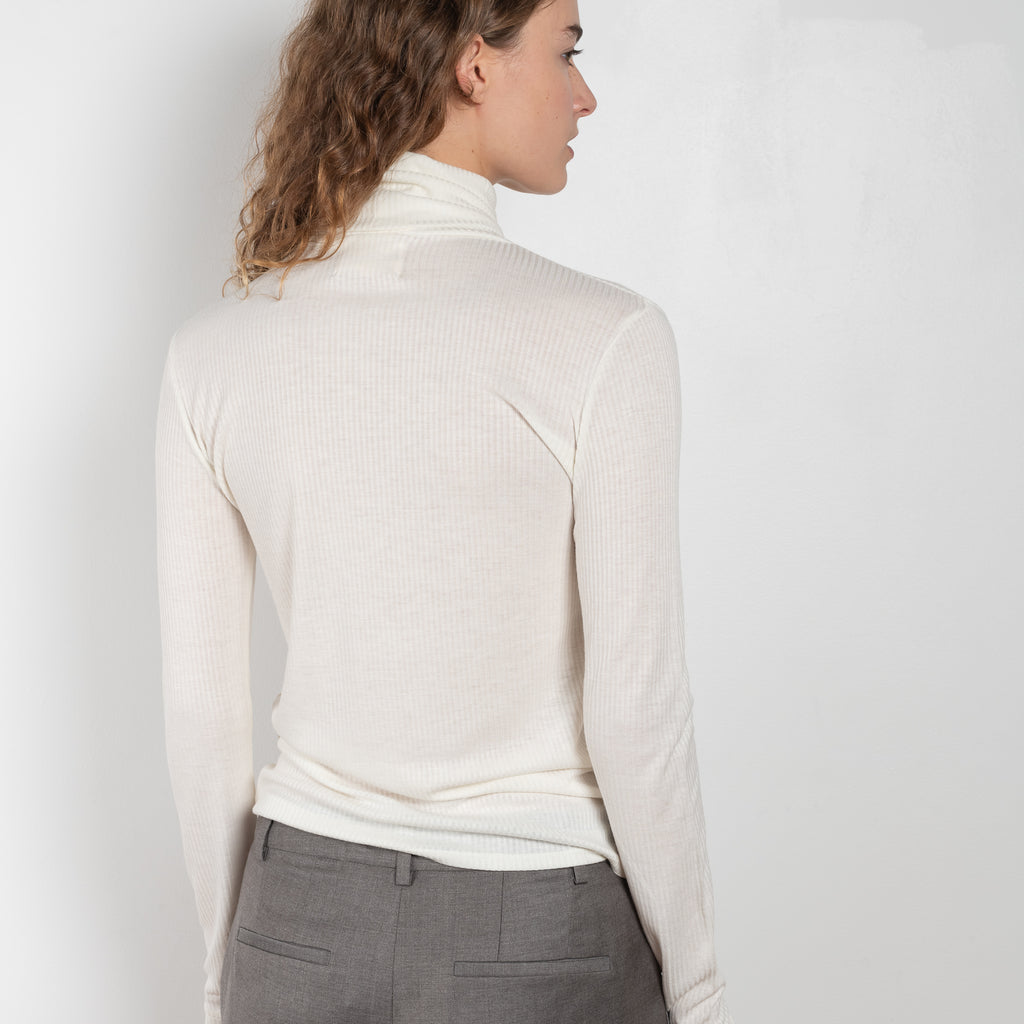 The Gallinara Turtleneck Tee by Loulou Studio is a fine ribbed turtleneck top in a soft wool blend 