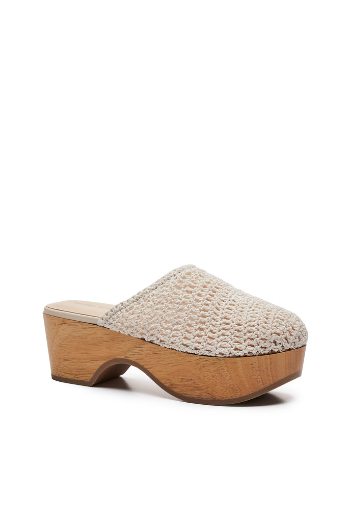 The Crochet Clogs by Magda Butrym are clog mules with a wooden platform, a rubber sole and a crochet upper