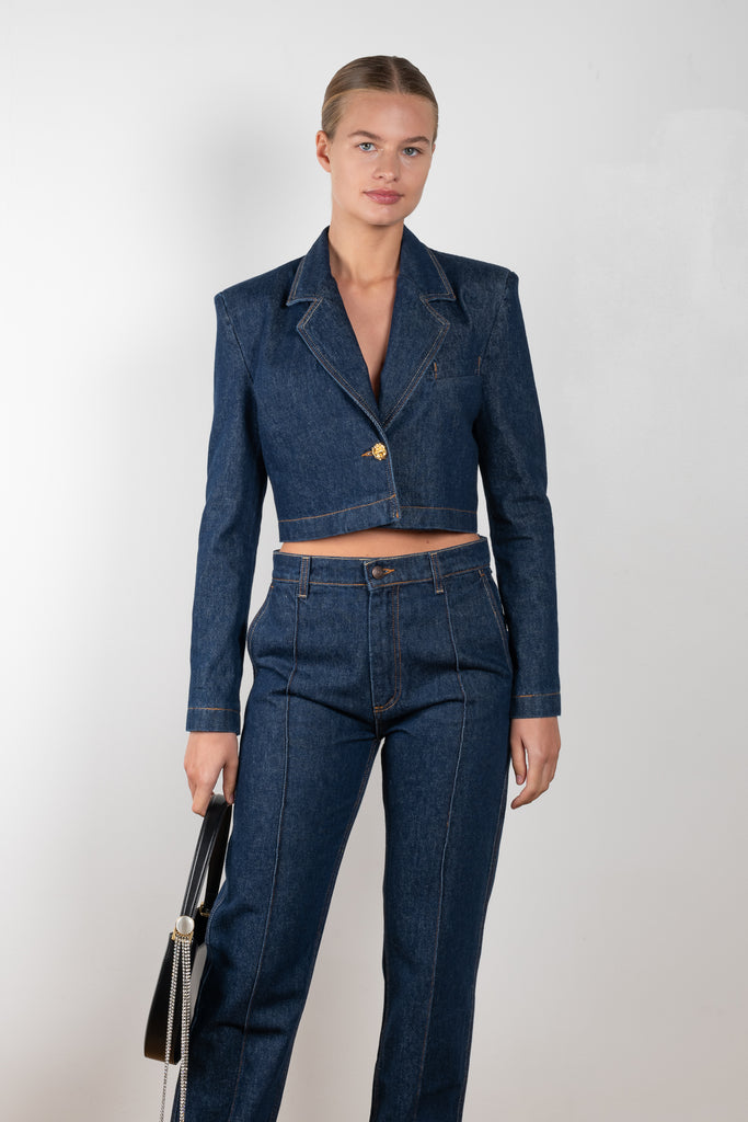The Denim Blazer 13 by Magda Butrym is a fitted copped denim blazer made from structured cotton, with golden rose mini buttons