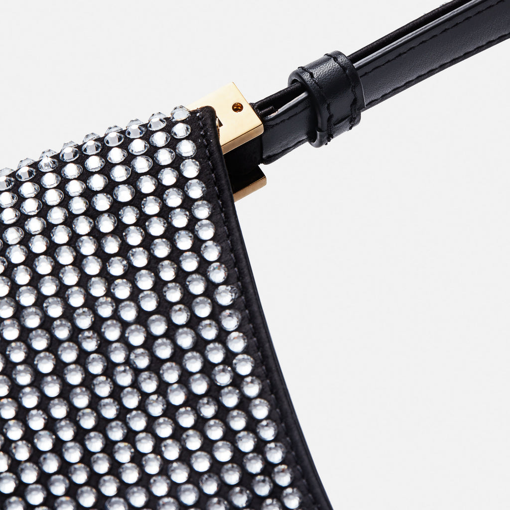The Medium Vesna bag by Magda Butrym is a hobo bag with a classic yet trendy shape covered in crystals with a detachable signature strass brooch