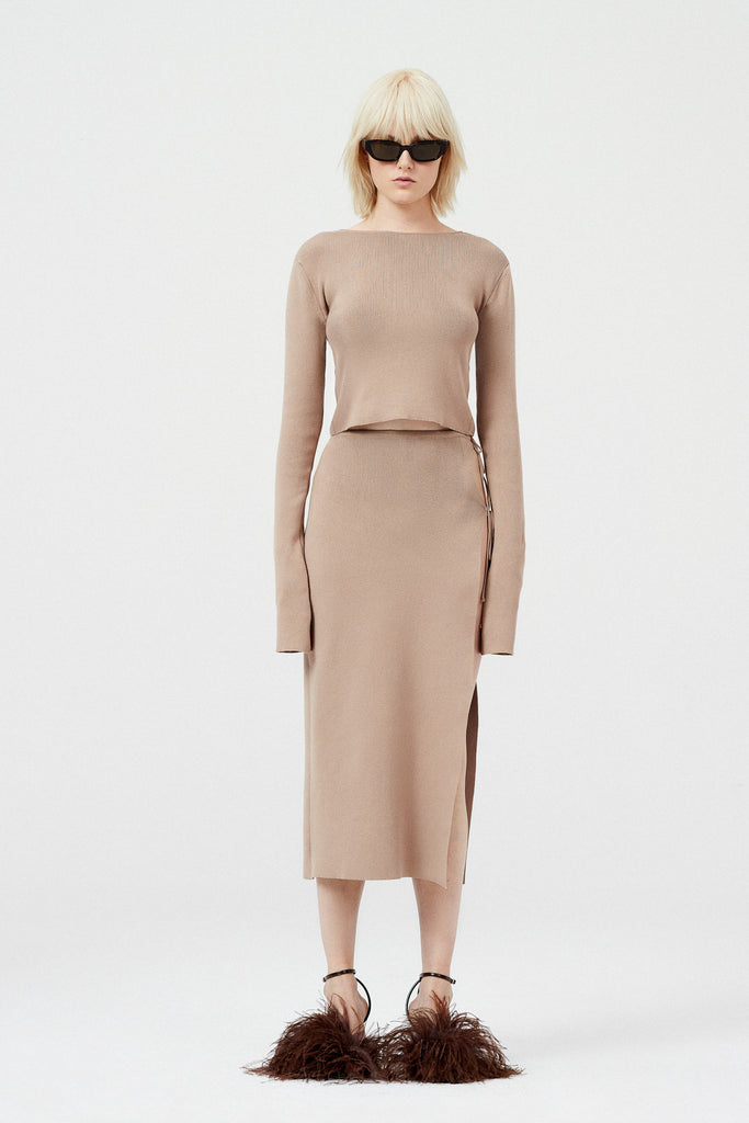 The Knit Cutout Skirt 09 by Magda Butrym is a lightweight knitwear midi skirt with an open side and cutout at the hip, with two ties as closure