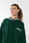 The Crewneck Sweater by Meryll Rogge is a loose sweater with asymmetrical sleeves and details