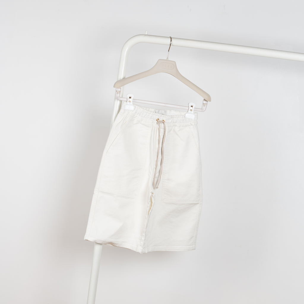 The Hadi Bermuda by Nanushka is a high waisted denim bermuda with vegan leather patch pockets on the back 