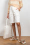 The Hadi Bermuda by Nanushka is a high waisted denim bermuda with vegan leather patch pockets on the back 