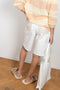 The Hadi Bermuda by Nanushka is a high waisted denim bermuda with vegan leather patch pockets on the back 