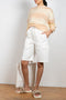 The Hadi Bermuda by Nanushka is a high waisted denim bermuda with vegan leather patch pockets on the back 