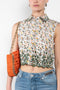 The Floral Shirt by Paco Rabanne is a crisp cotton sleeveless shirt with a floral print and contrasted floral embroidery