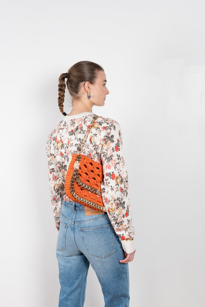 The Floral Sweater by Paco Rabanne is a cropped boxy sweater with a raw cut hem in a seasonal flower print