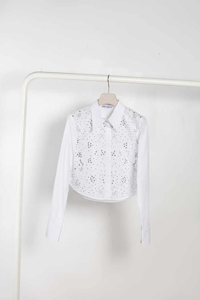 The Studded Shirt by Paco Rabanne is a crisp cotton shirt with a boxy fit and all-over studs